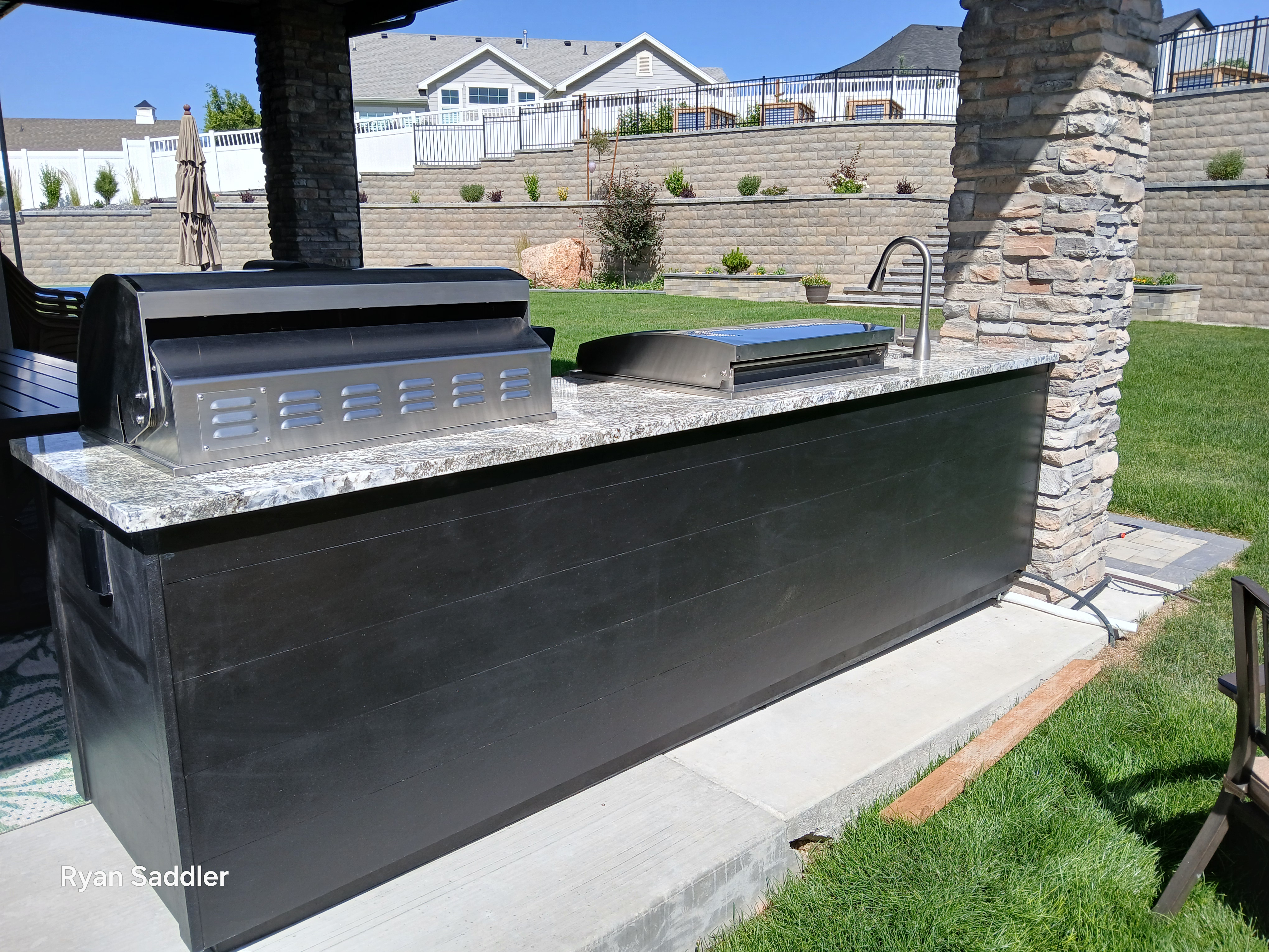 Modern outdoor kitchen with steel siding cladding