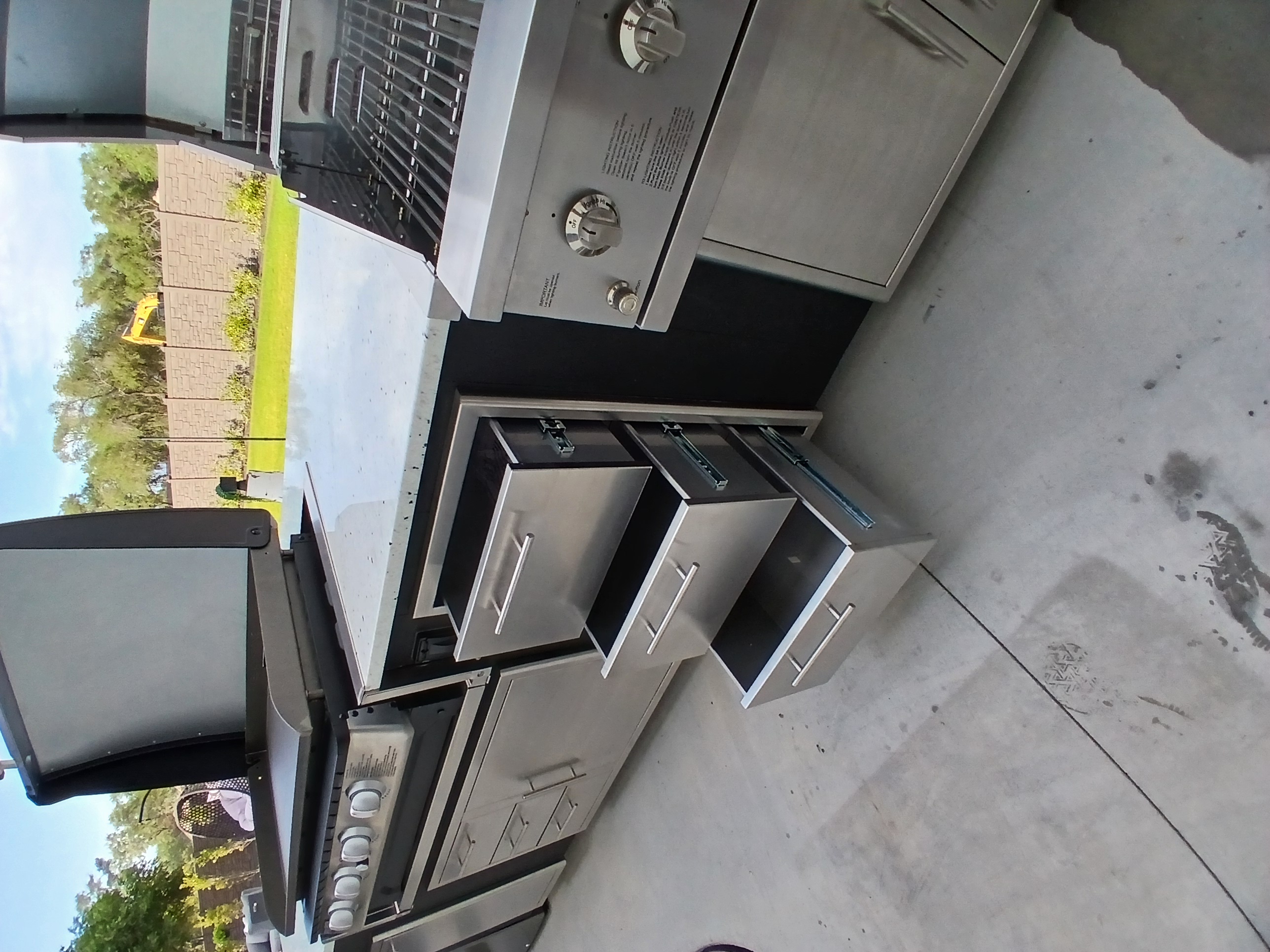 Stainless steel grill installation with storage